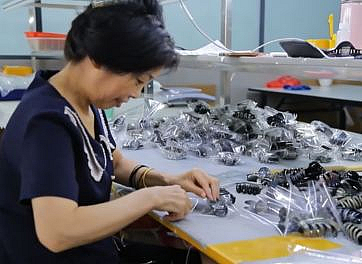 Workers packing acetate hair clips