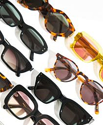 Eight acetate sunglasses were placed on the table.
