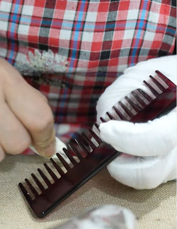Workers wipe the acetate combs.