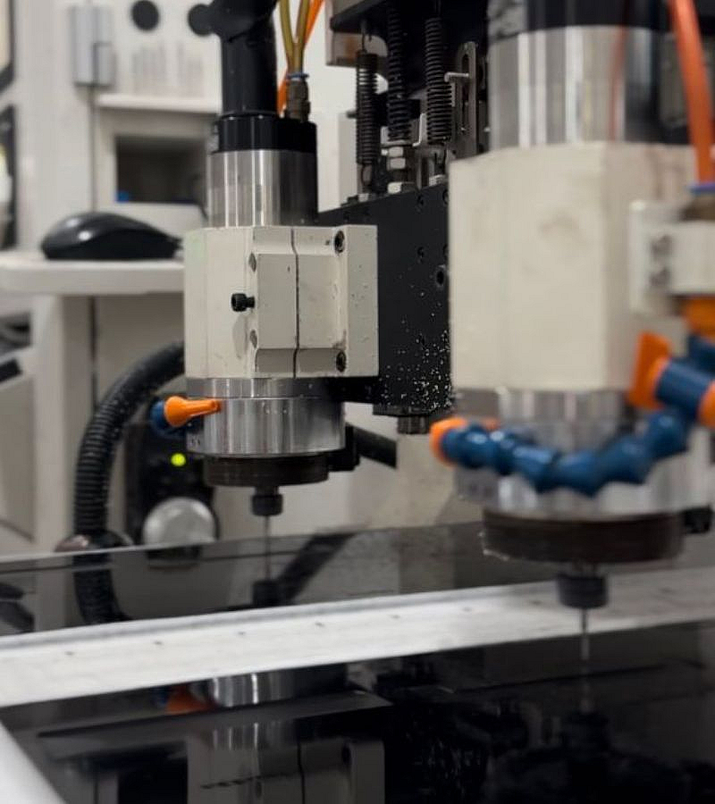 CNC machine cutting black acetate board